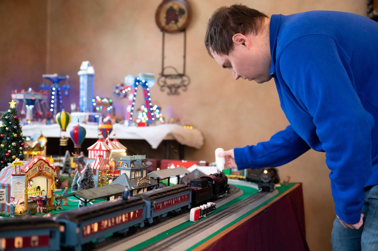 Lance adding smoke fluid to a model locomotive